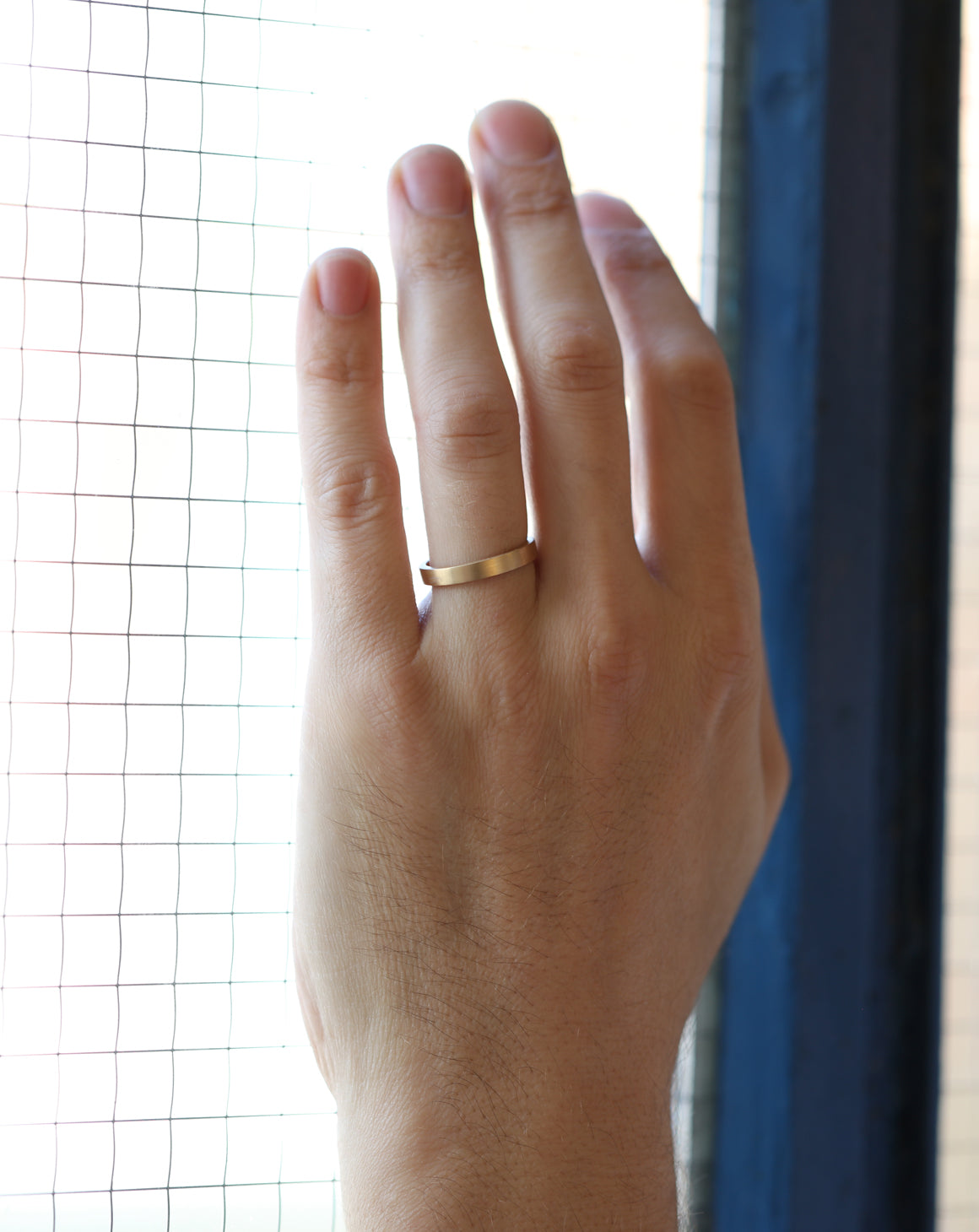 Flat wedding band. 18ct yellow gold, satin finish. On hand.
