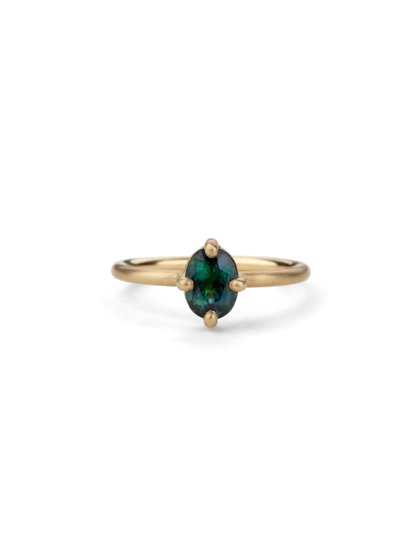 Solitaire ring with oval teal sapphire. 18ct yellow gold, satin finish.