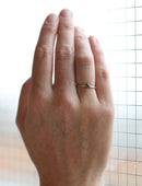 Solitaire ring with round teal sapphire. 18ct yellow gold, satin finish. On hand.