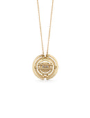 Geometric pendant with concentric circles surrounding yellow sapphire. 18ct yellow gold, textured finish. Back detail.