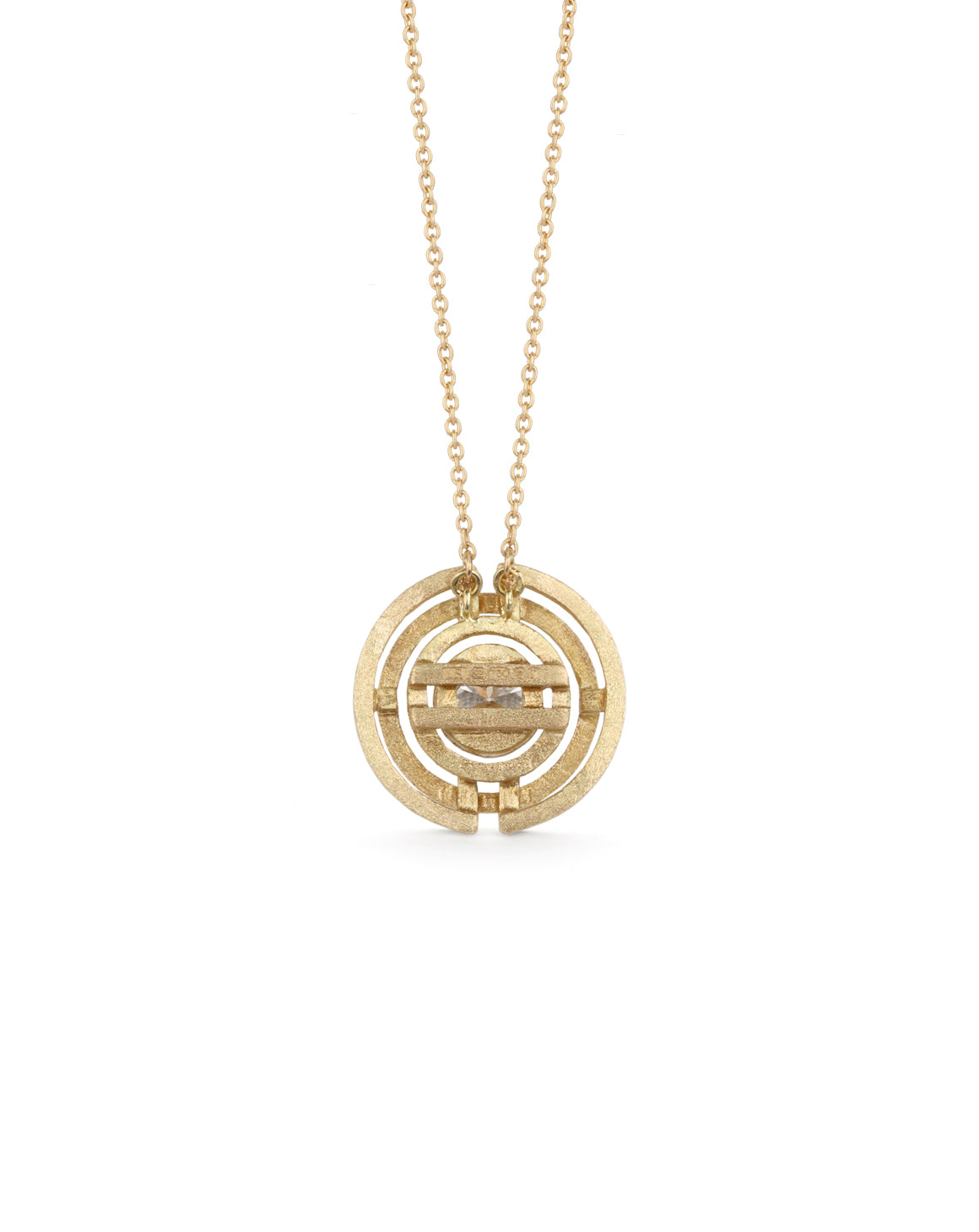 Geometric pendant with concentric circles surrounding yellow sapphire. 18ct yellow gold, textured finish. Back detail.