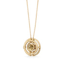 Geometric pendant with concentric circles surrounding yellow sapphire. 18ct yellow gold, textured finish. Side detail.
