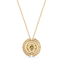 Geometric pendant with concentric circles surrounding yellow sapphire. 18ct yellow gold, textured finish.