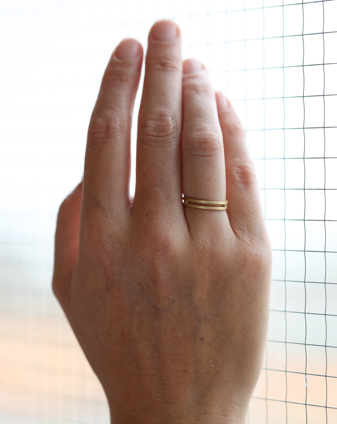 18ct yellow gold double band with textured finish on hand