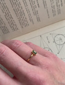 Rectangular green sapphire ring, four claw setting. 18ct yellow gold, polished finish. On hand.