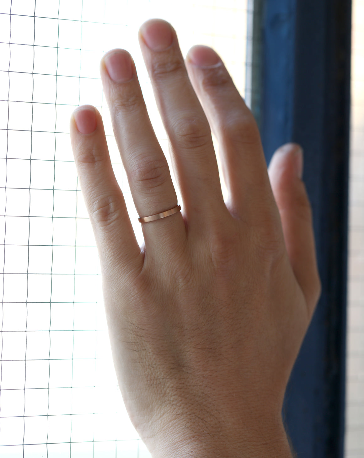 Flat wedding band. 18ct yellow gold, satin finish. On hand.