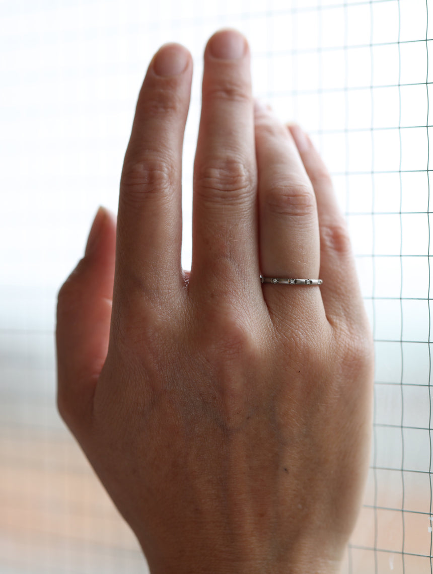 Rounded band set with tiny white diamonds. 18ct yellow gold, satin finish.
