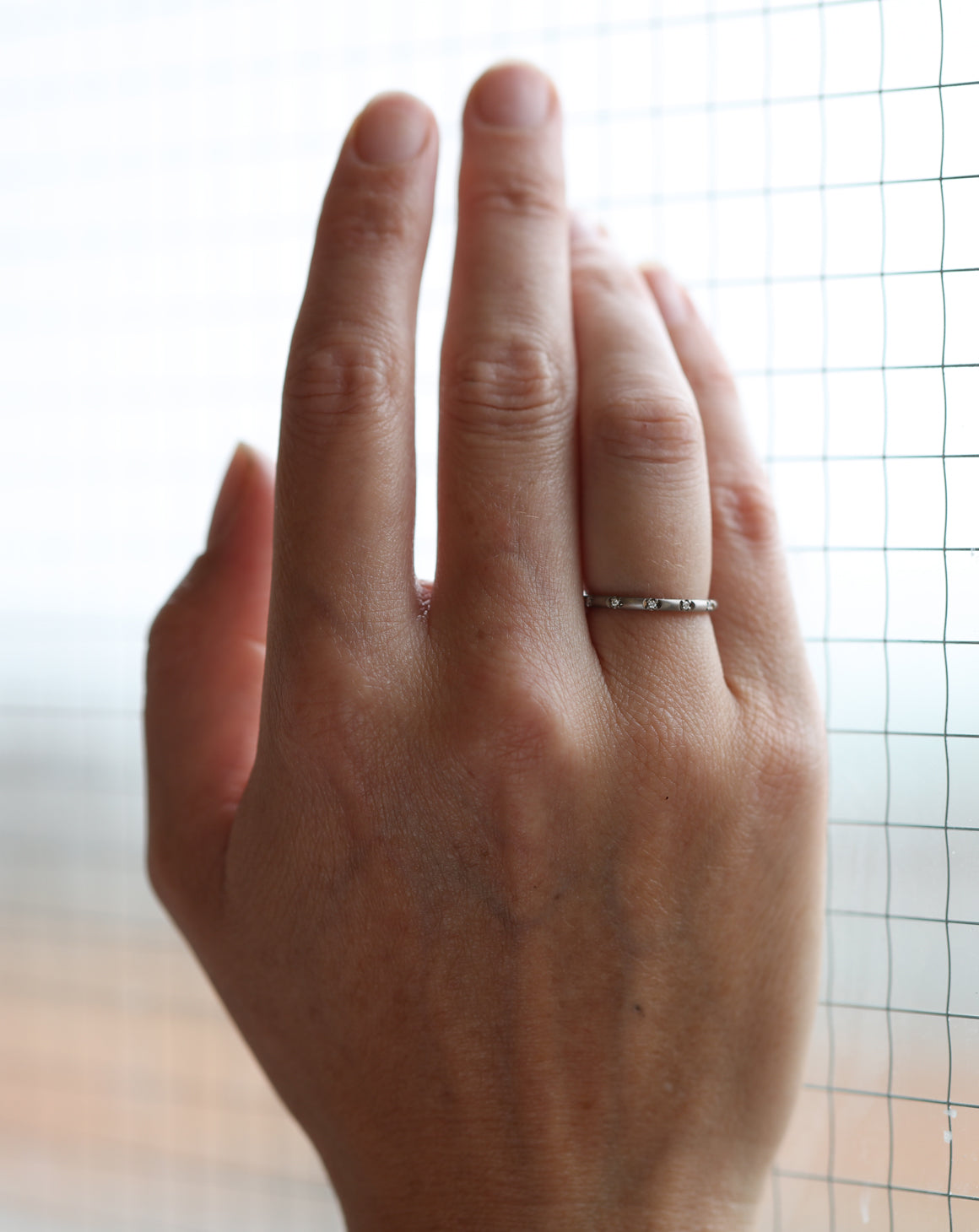 Rounded band set with tiny white diamonds. 18ct yellow gold, satin finish.