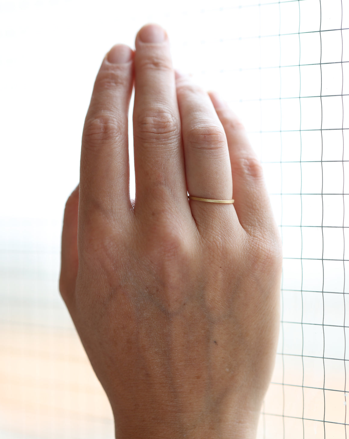 Flat wedding band. 18ct yellow gold, textured finish. Side view.