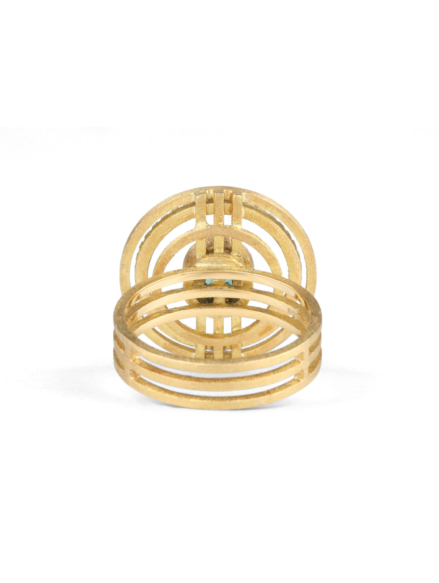 Geometric statement ring with central teal tourmaline and outer diamond set circle. 18ct yellow gold, textured finish. Back view.