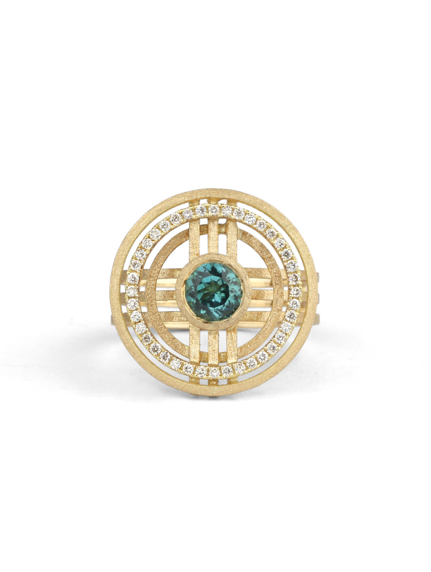 Geometric statement ring with central teal tourmaline and outer diamond set circle. 18ct yellow gold, textured finish.
