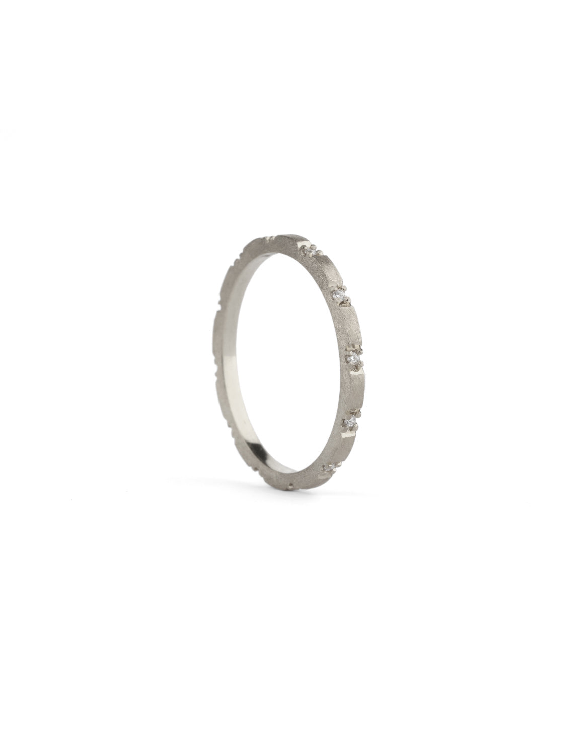 Fine ring band set with tiny white diamonds. 18ct white gold, textured finish.