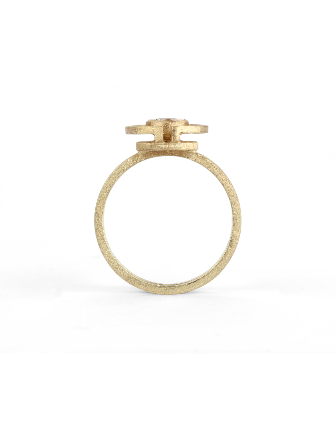 Geometric ring with a round white diamond and semicircle detail. 18ct yellow gold, textured finish. Side view.