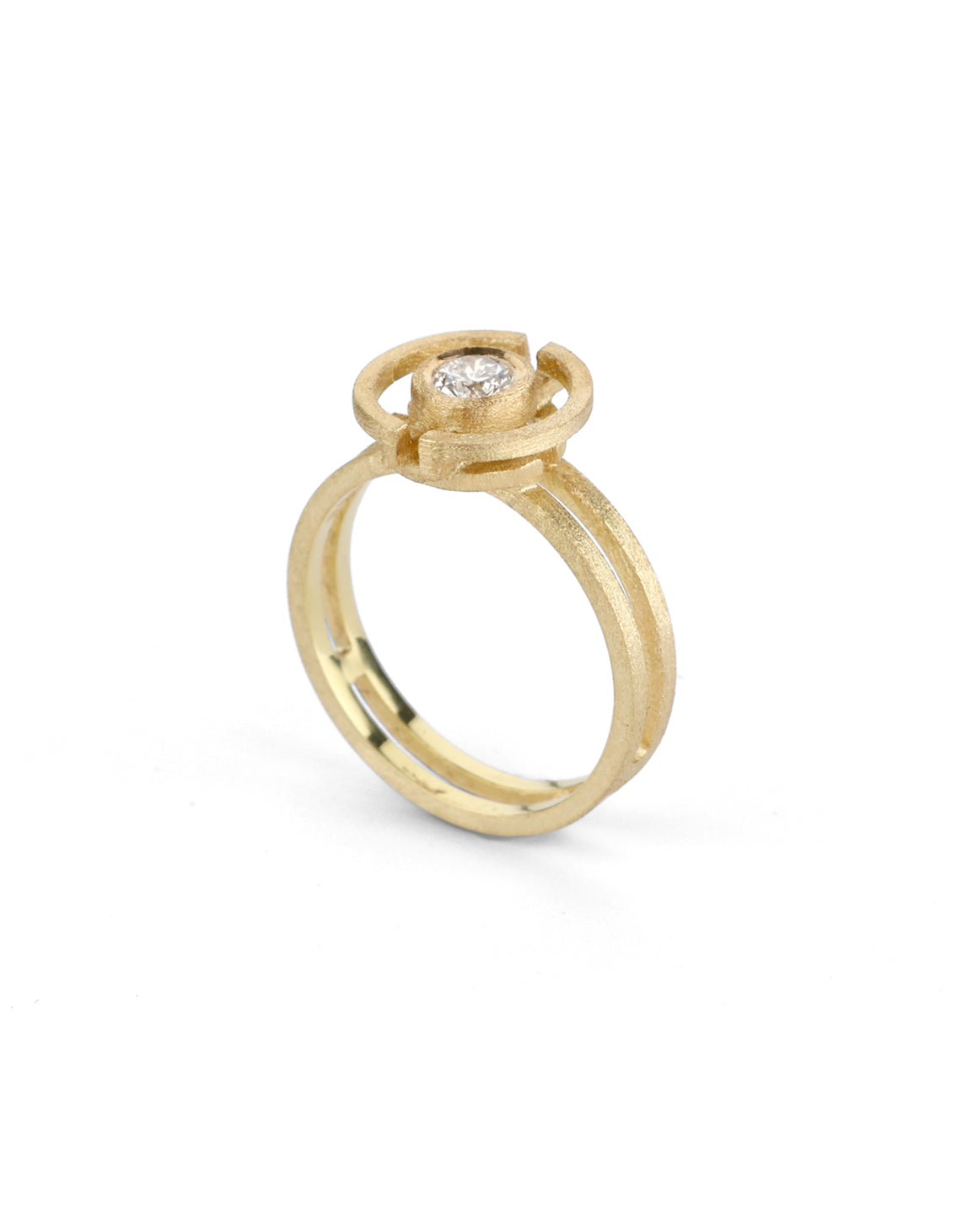 Geometric ring with a round white diamond and semicircle detail. 18ct yellow gold, textured finish.
