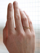 Diamond set double band ring. 18ct yellow gold. On the hand.