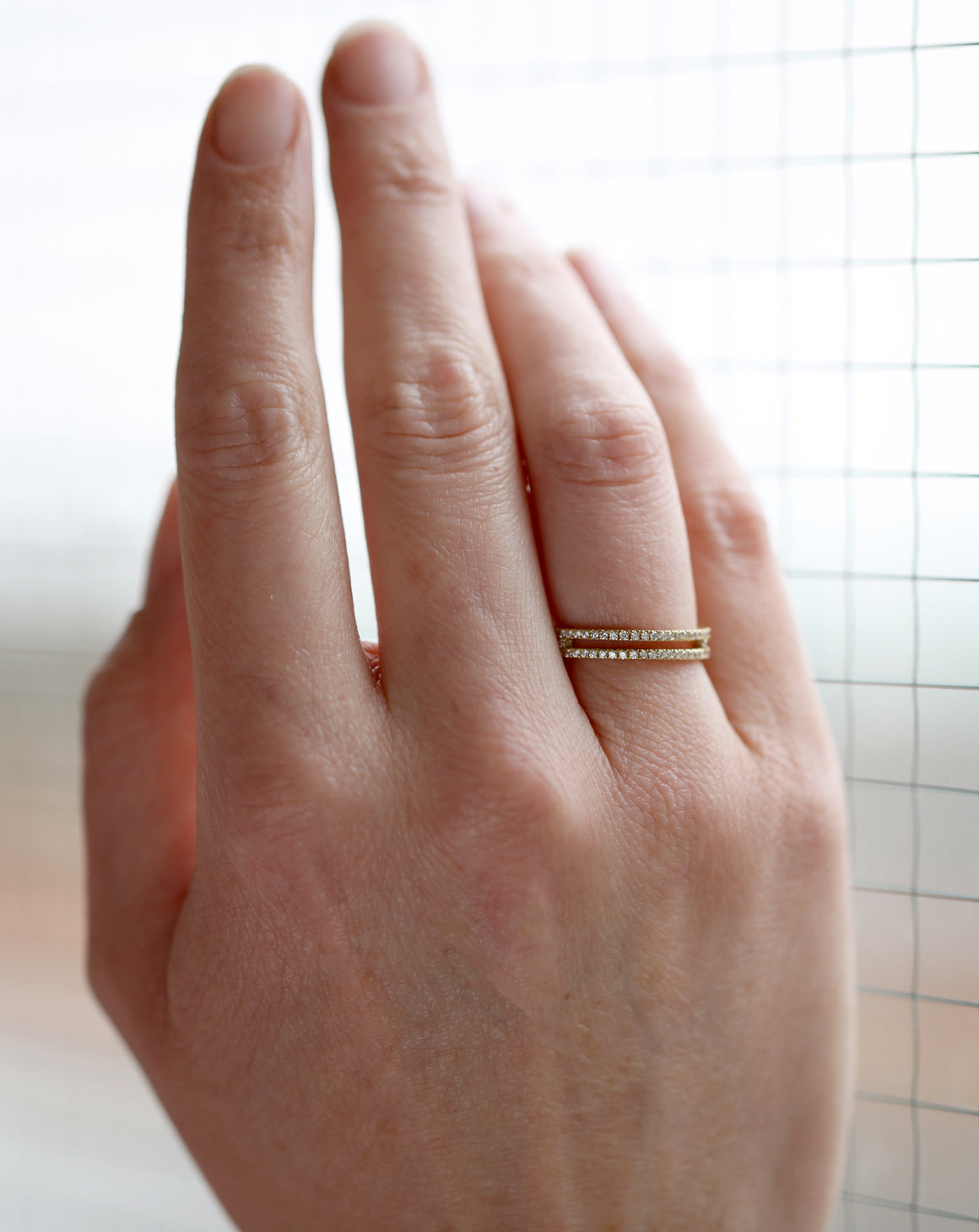 Diamond set double band ring. 18ct yellow gold. On the hand.