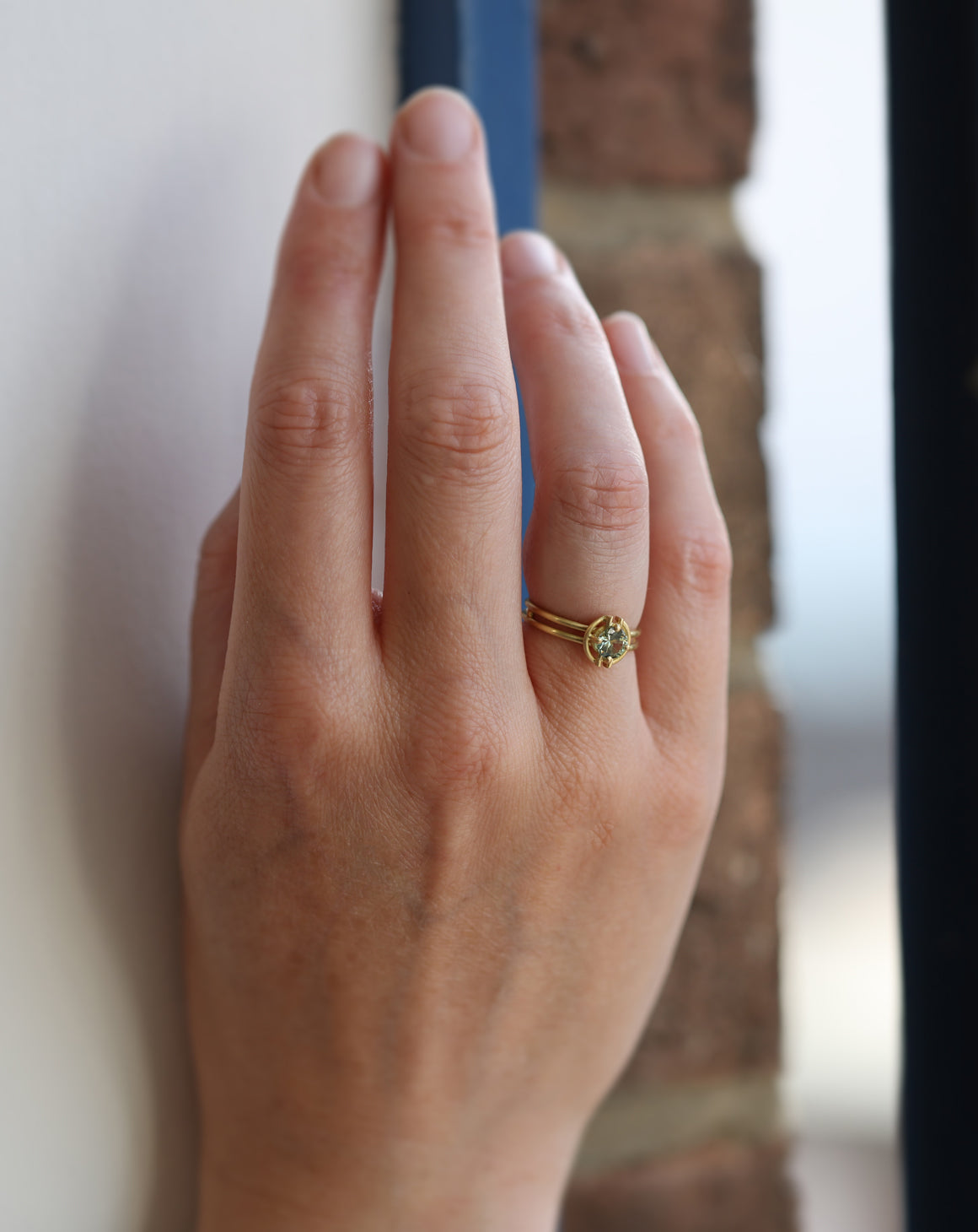 Round green sapphire ring with geometric detail. 18ct yellow gold, satin finish. n hand