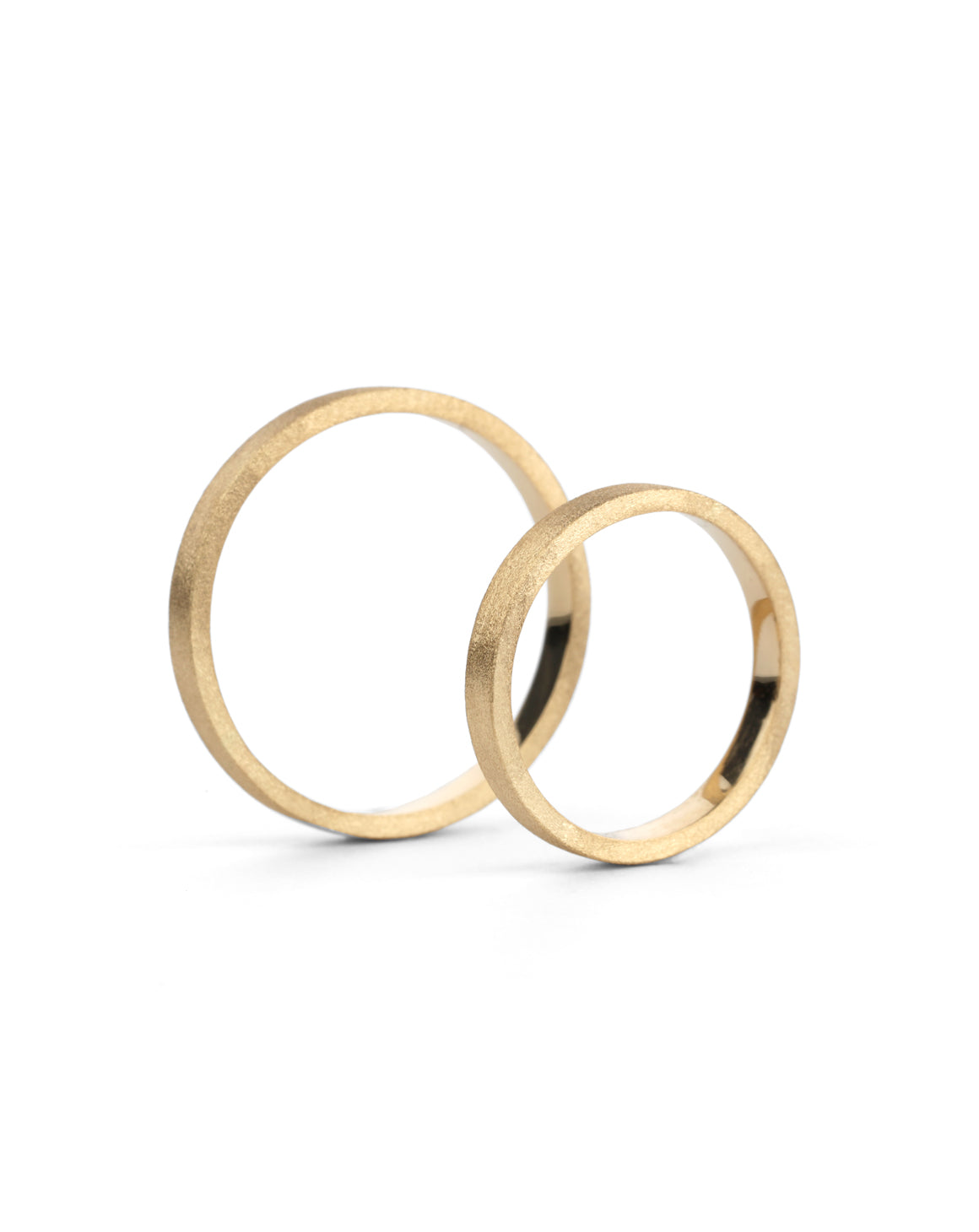 Two flat wedding bands. 18ct yellow gold, textured finish. Side view.