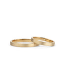 Two flat wedding bands. 18ct yellow gold, textured finish.
