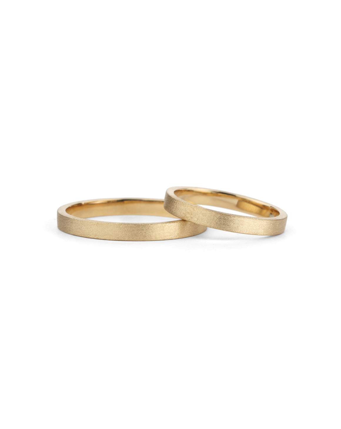 Two flat wedding bands. 18ct yellow gold, textured finish.