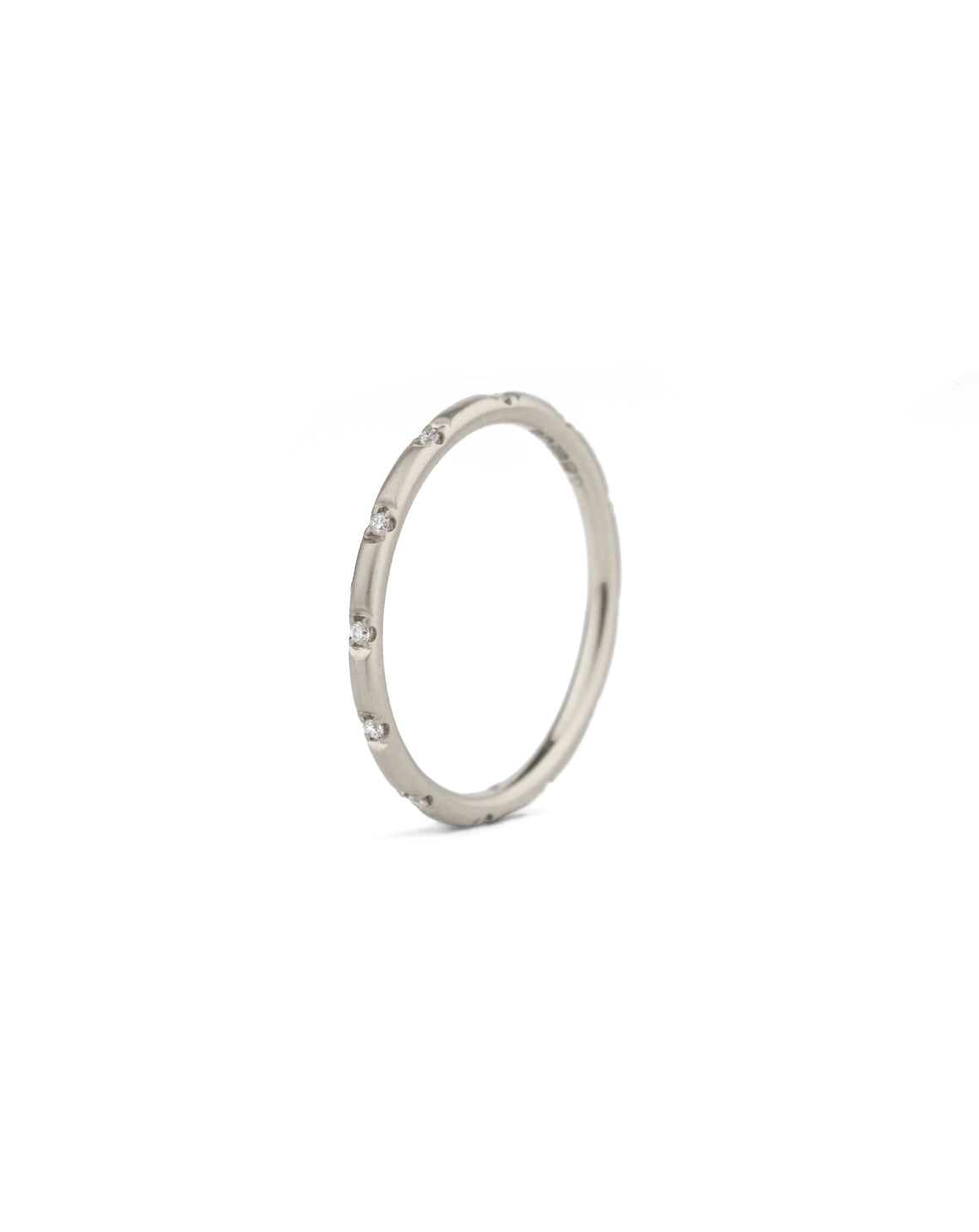 Rounded band set with tiny white diamonds. 18ct white gold, satin finish.